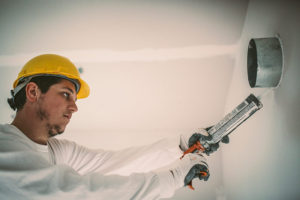 Skilled technician sealing a surface